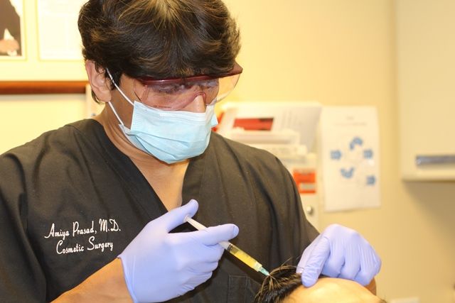 Dr. Prasad performing TrichoStem® Hair Regeneration procedure.